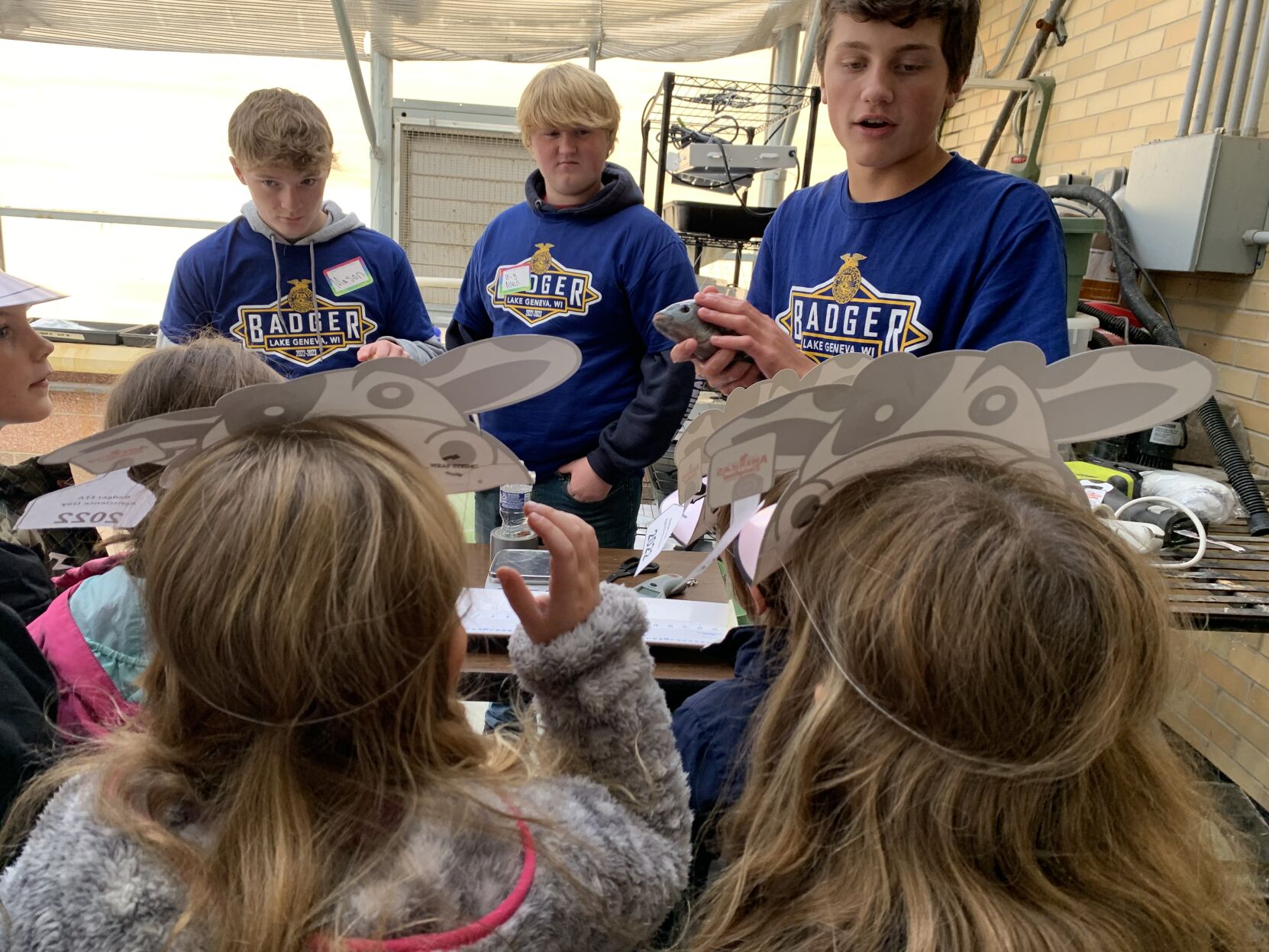 Badger High School agriculture students talk to third graders about how fish are labeled and measured